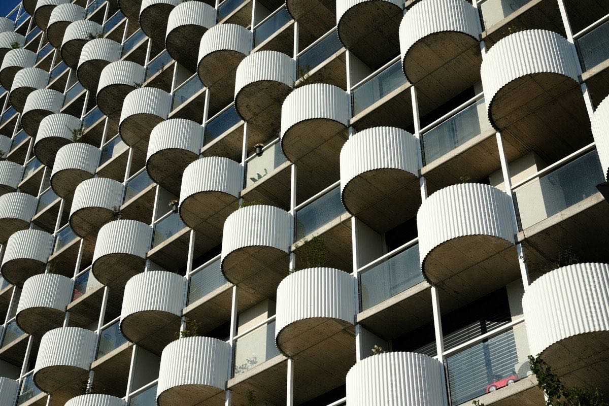 Repeating concrete balconies and panel joints on a building facade